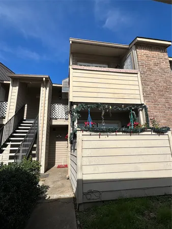 a view of a house with a balcony and stairs