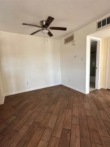 a view of a livingroom with a hardwood floor and a ceiling fan