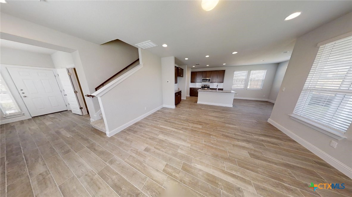 116 Hidden Branch Cove Maxwell, TX 78656 - Photo 5 of 23 a view of a kitchen with wooden floor and electronic appliances
