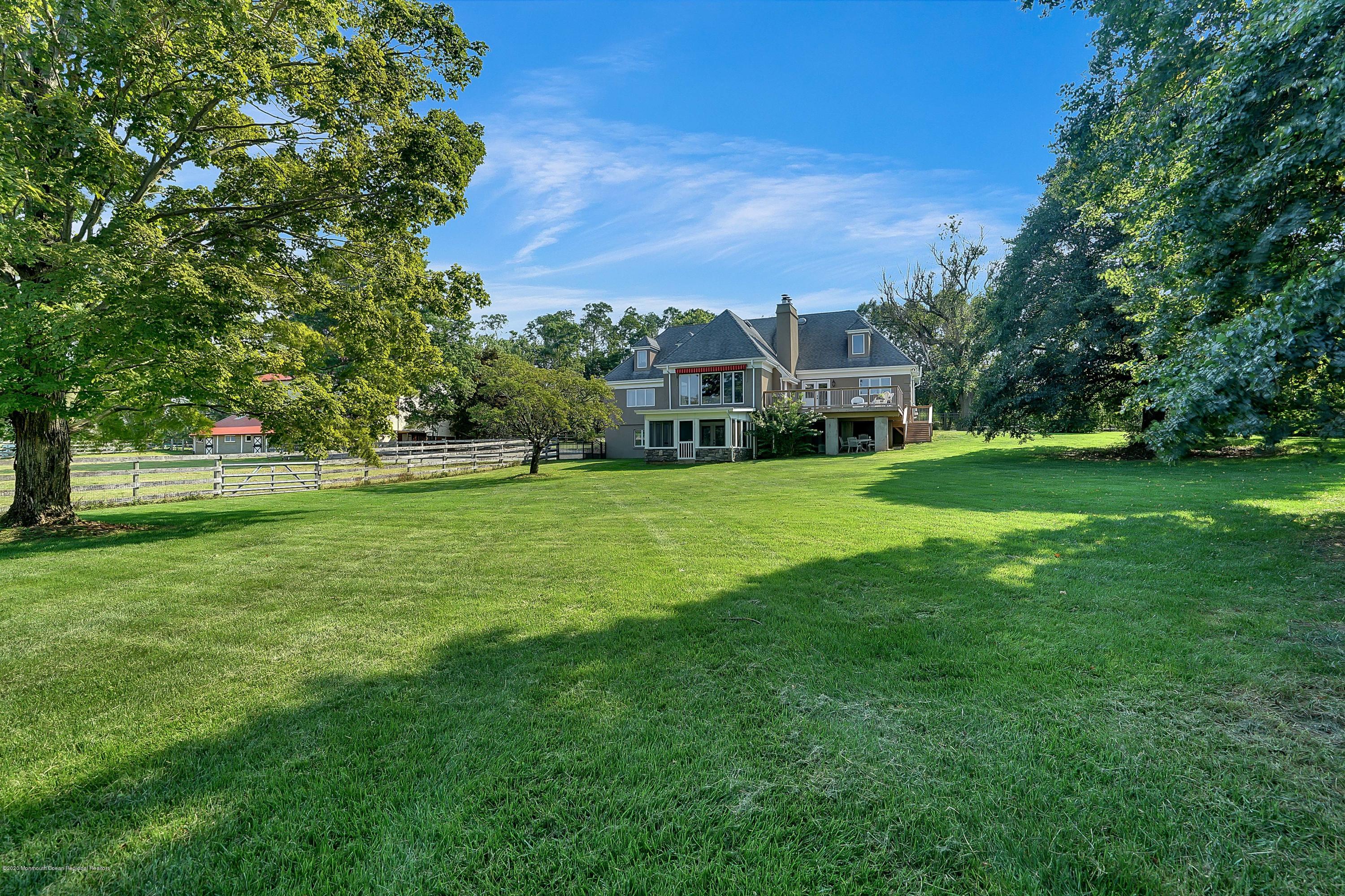56 Hominy Hill Road Colts Neck, NJ 07722 - Photo 103 of 106 a view of a big yard with a house in the background