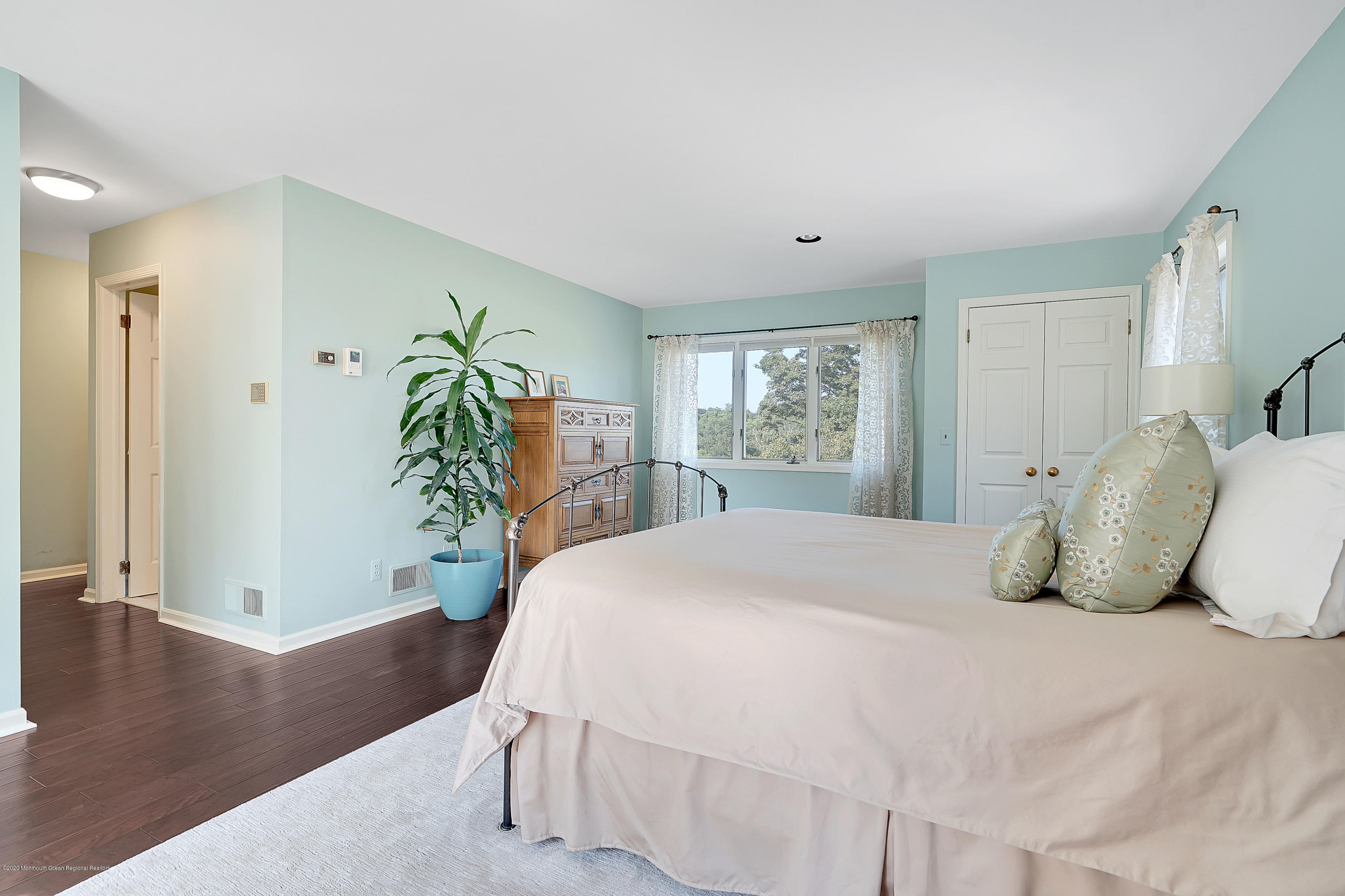 56 Hominy Hill Road Colts Neck, NJ 07722 - Photo 32 of 106 a bedroom with a large bed and wooden floor