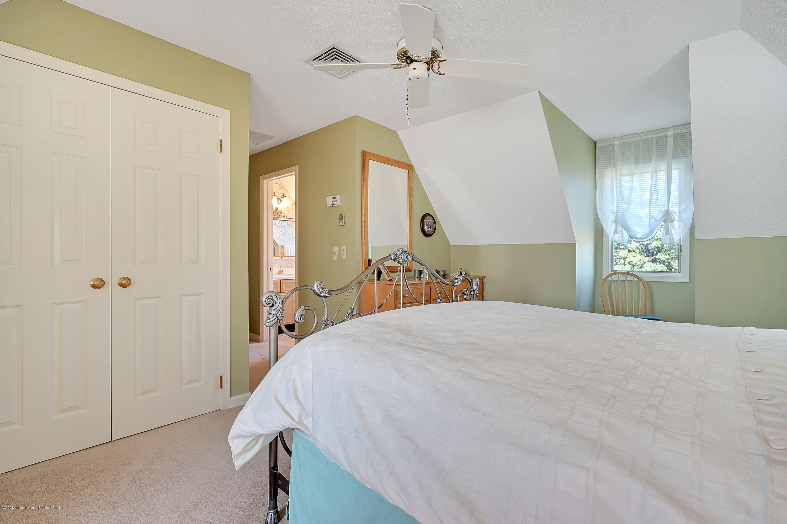56 Hominy Hill Road Colts Neck, NJ 07722 - Photo 43 of 106 a bedroom with a bed and a chandelier