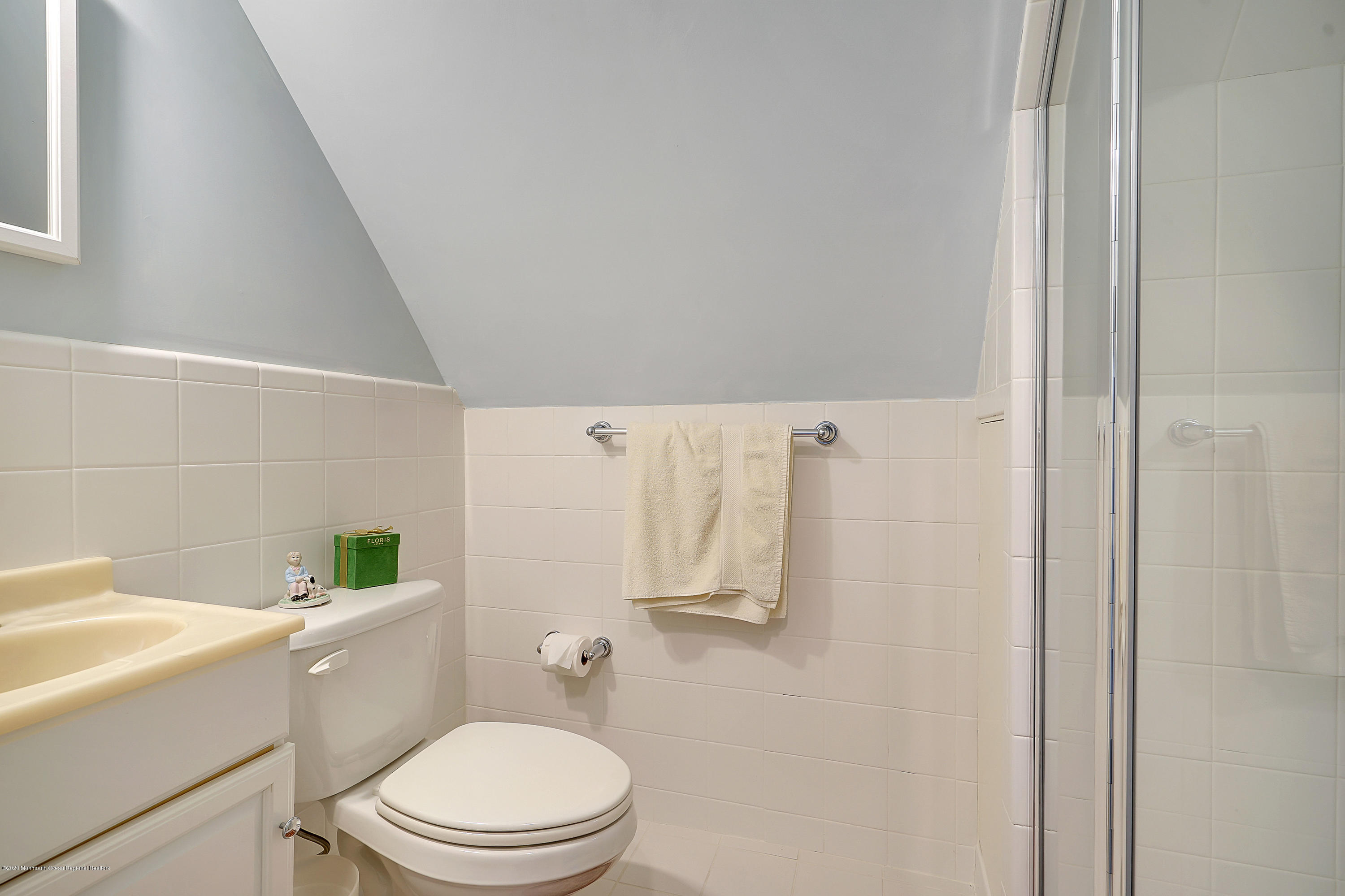 56 Hominy Hill Road Colts Neck, NJ 07722 - Photo 46 of 106 a white toilet sitting next to a white sink and vanity