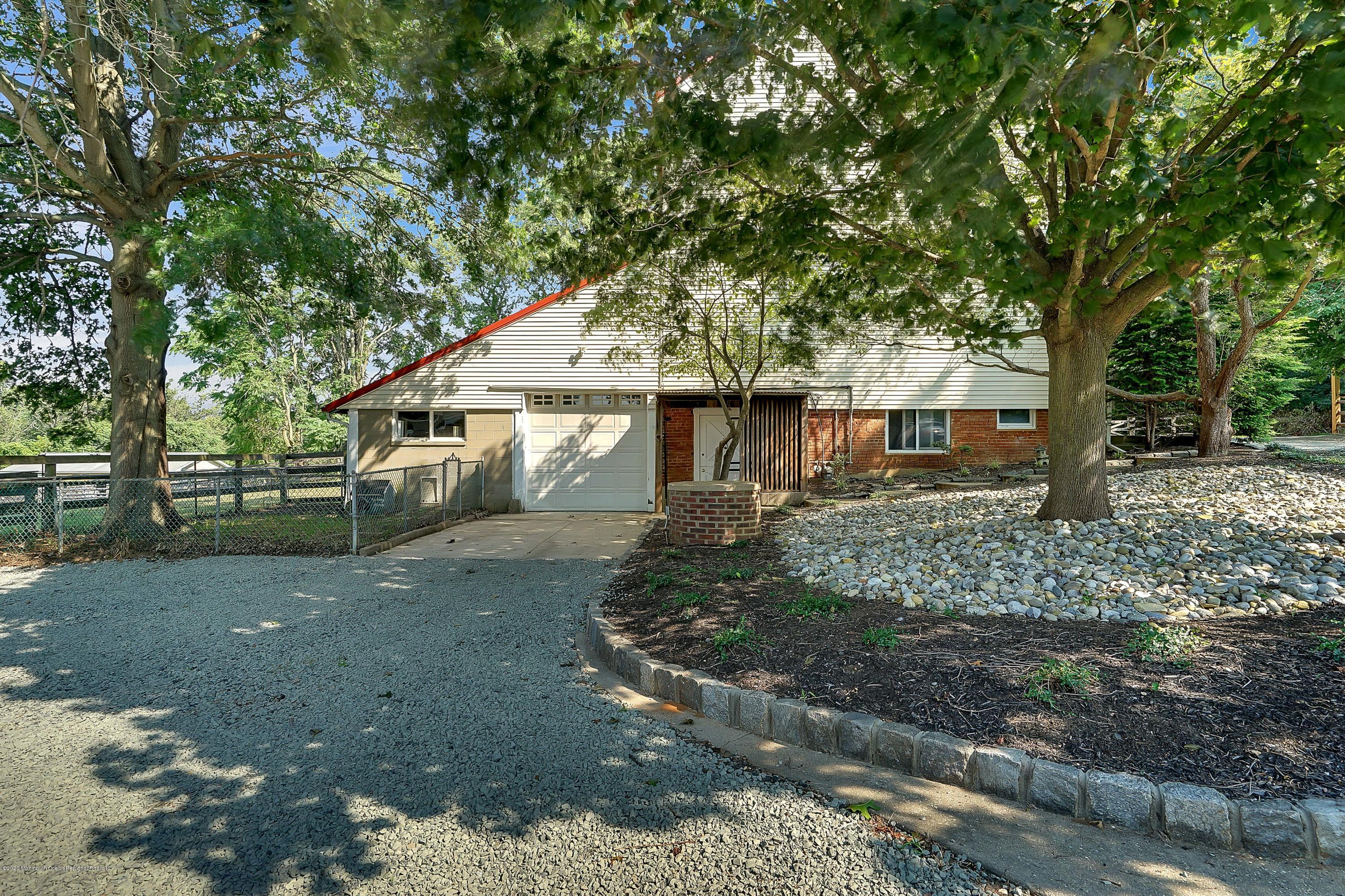 56 Hominy Hill Road Colts Neck, NJ 07722 - Photo 77 of 106 a front view of a house with a garden