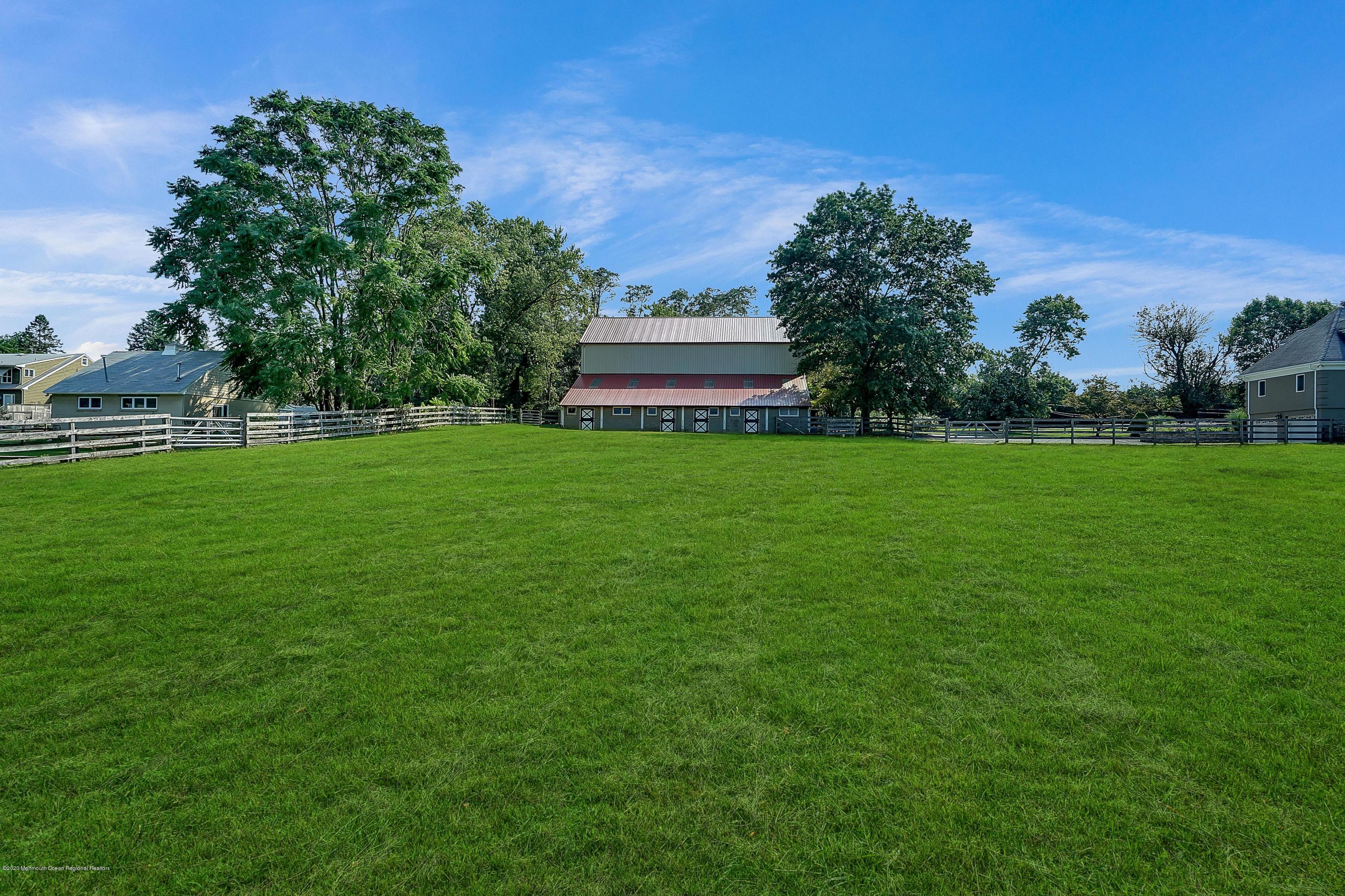 56 Hominy Hill Road Colts Neck, NJ 07722 - Photo 93 of 106 a front view of a house with a garden