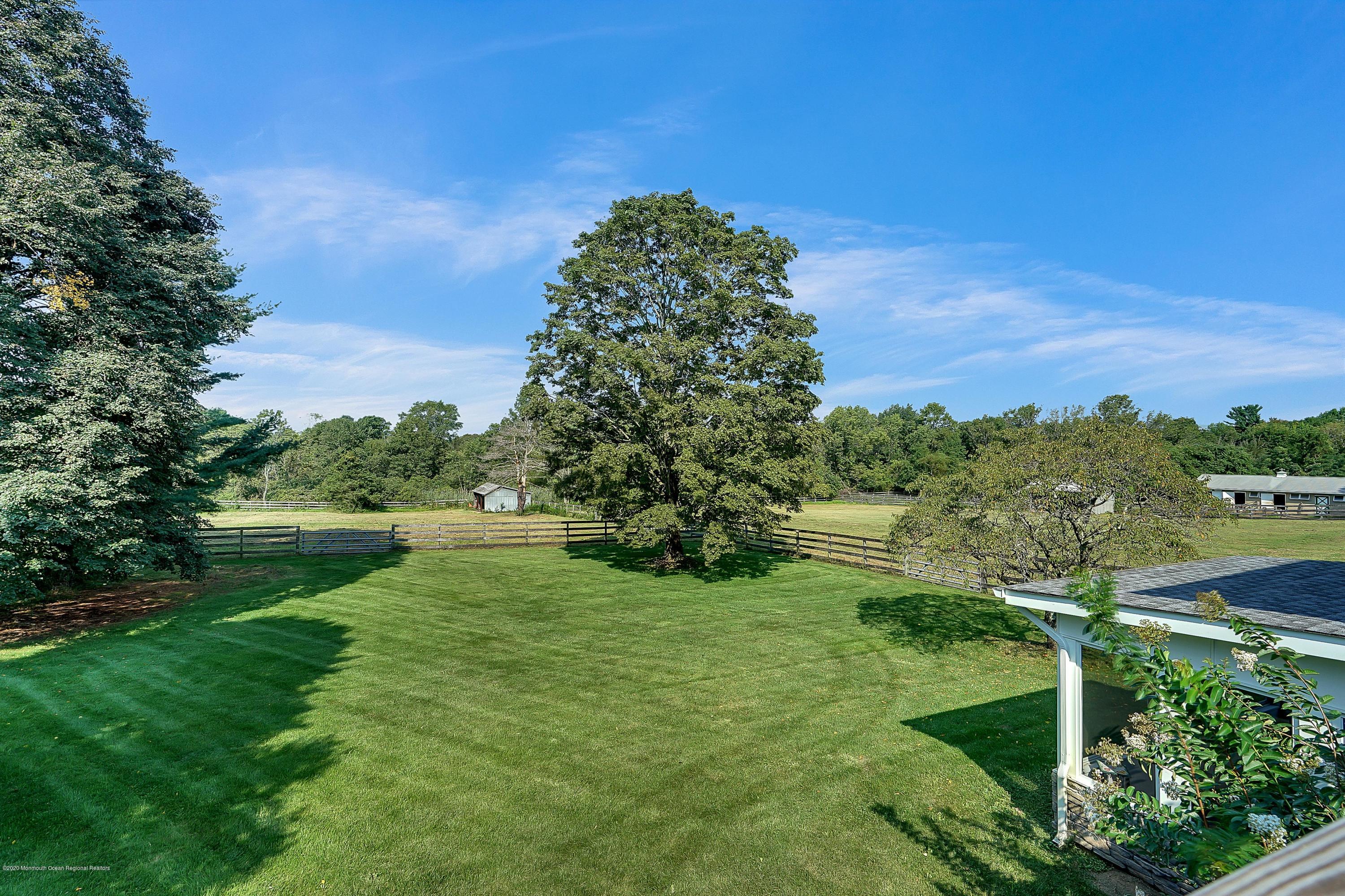 56 Hominy Hill Road Colts Neck, NJ 07722 - Photo 96 of 106 a view of a garden with a lake