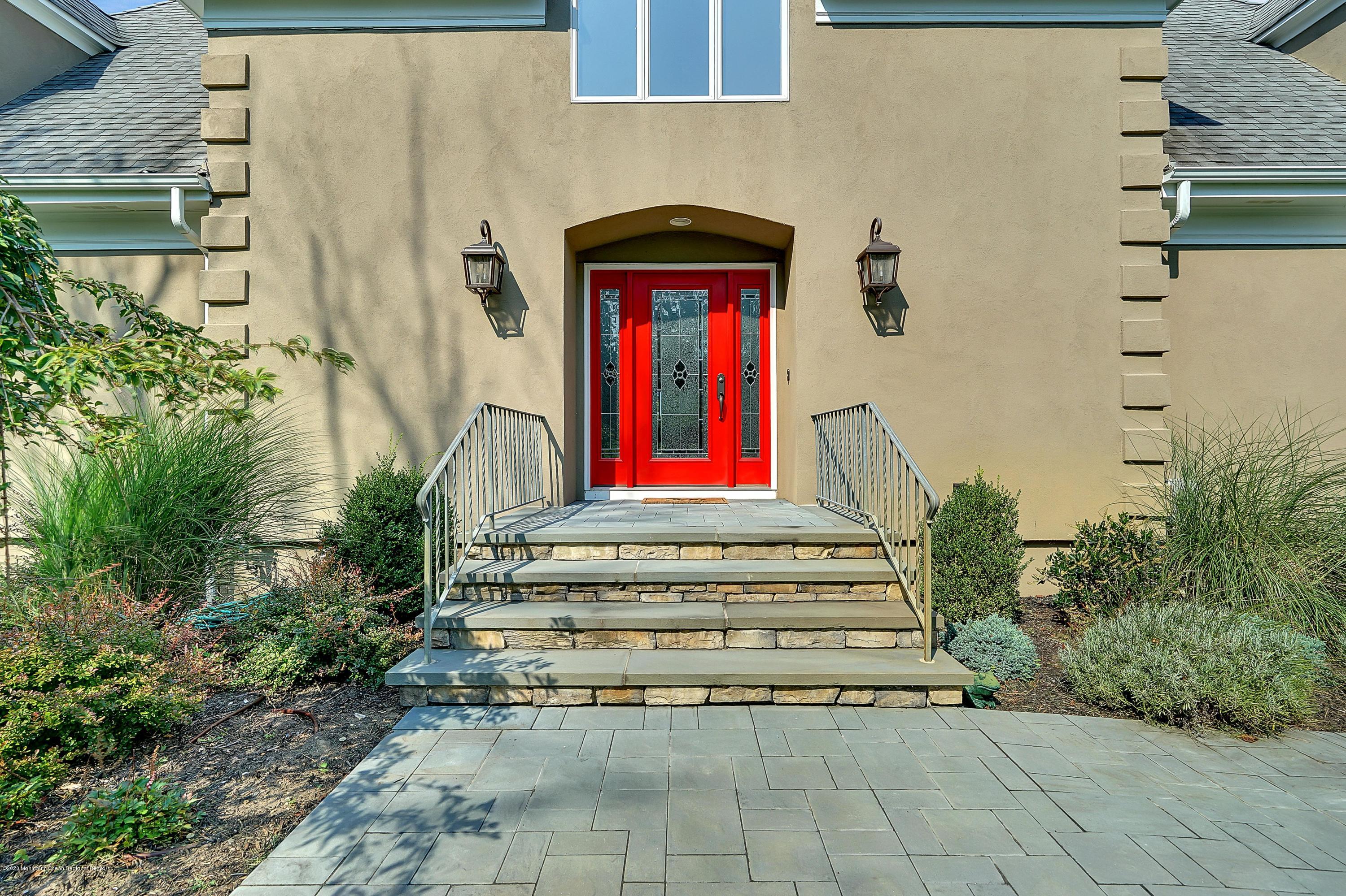 56 Hominy Hill Road Colts Neck, NJ 07722 - Photo 10 of 106 a front view of a house with large windows