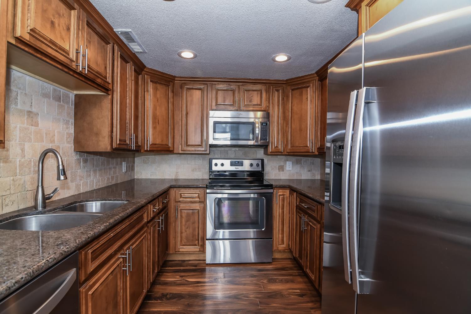 1139 Rivara Circle Sacramento, CA 95864 - Photo 19 of 72 a kitchen with granite countertop a sink stainless steel appliances and cabinets
