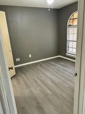 an empty room with windows and entrance