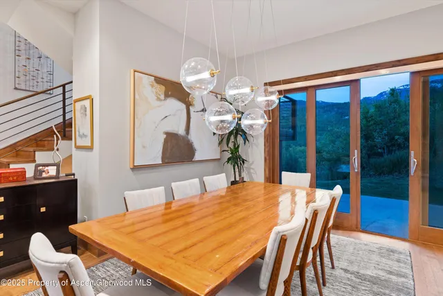 a dining room with a table and chairs