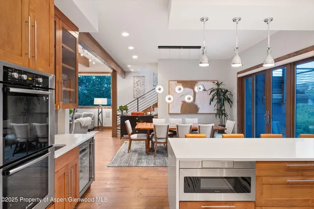 a kitchen with stainless steel appliances kitchen island granite countertop a stove a sink and a refrigerator