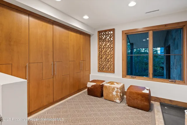 a bedroom with two beds and a large mirror