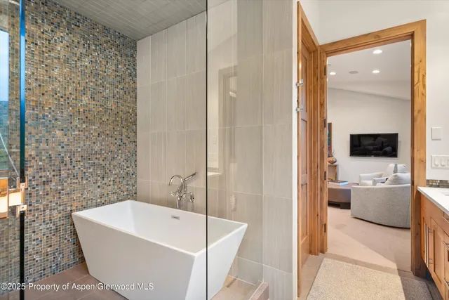 a living room with furniture a rug and a painting on the wall