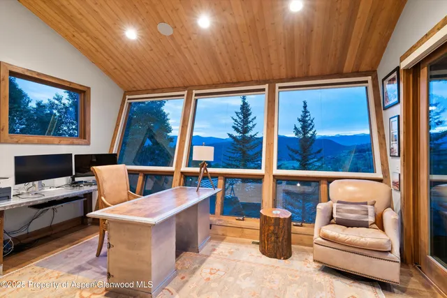 a dining room with furniture and front door