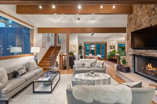 a living room with fireplace furniture and a flat screen tv