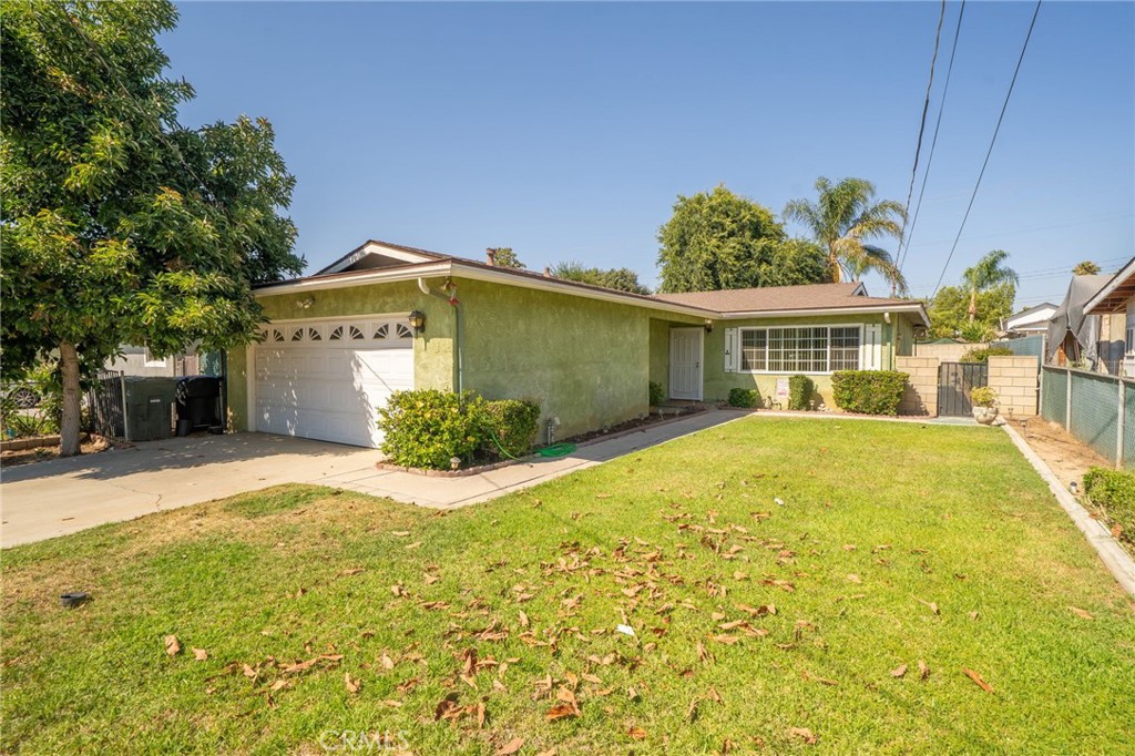 3133 Juanita Street Riverside, CA 92504 - Photo 1 of 1 a view of a white house with a yard