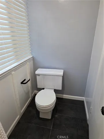 a white toilet sitting in a bathroom