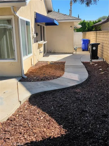 a view of a backyard with wooden fence