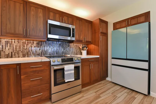 a roof deck with couches and wooden floor