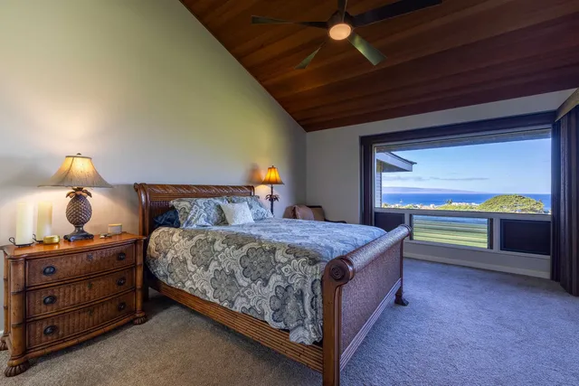 a bedroom with a large bed and a window