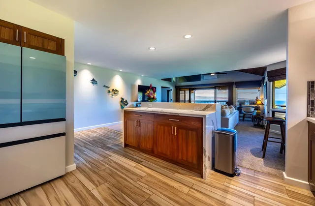 a view of entryway and hall with wooden floor