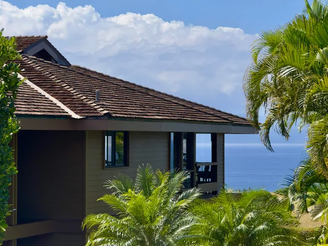 a kitchen with stainless steel appliances granite countertop wooden cabinets a sink a stove a dining table and chairs with wooden floor