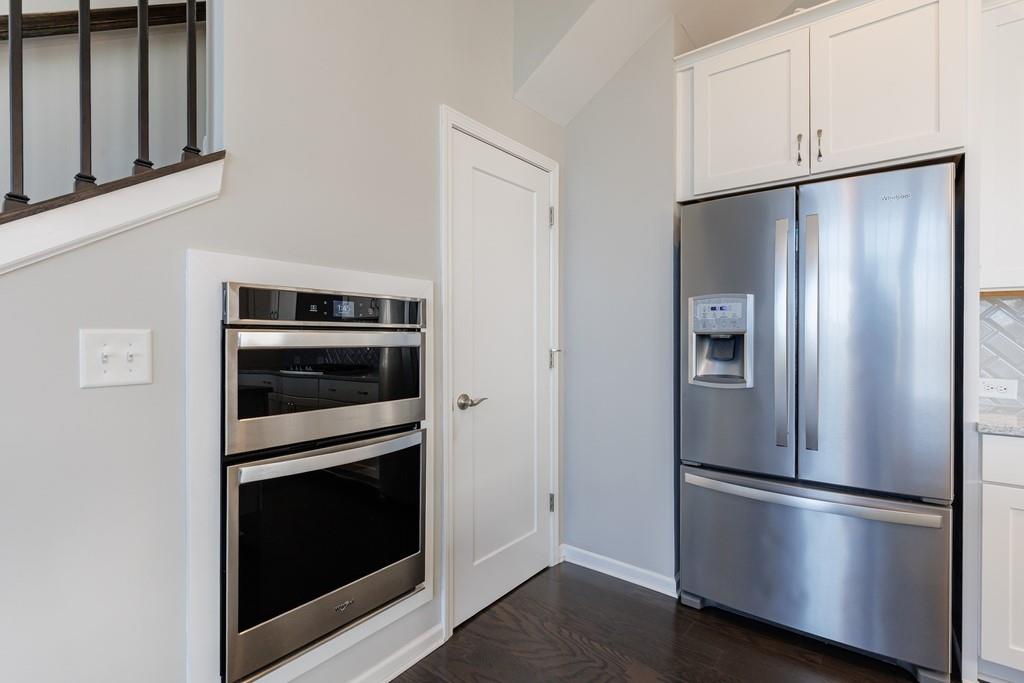 225 Britten Pass Alpharetta, GA 30009 - Photo 12 of 38 a metallic refrigerator freezer and a stove sitting inside of a kitchen