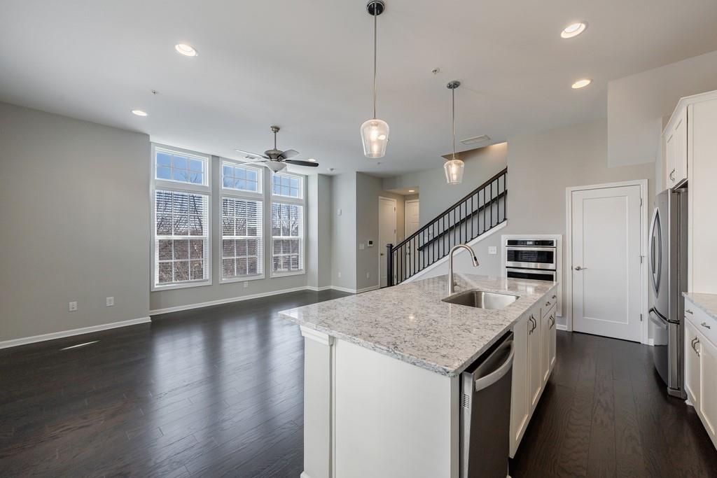 225 Britten Pass Alpharetta, GA 30009 - Photo 16 of 38 a kitchen with granite countertop a stove and a sink