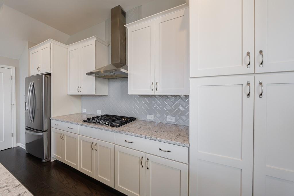 225 Britten Pass Alpharetta, GA 30009 - Photo 18 of 38 a kitchen with stainless steel appliances white cabinets and a refrigerator