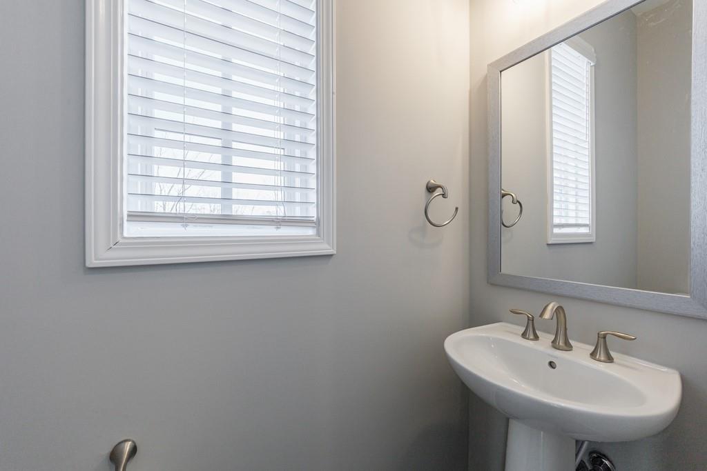 225 Britten Pass Alpharetta, GA 30009 - Photo 19 of 38 a bathroom with a sink a mirror and a window
