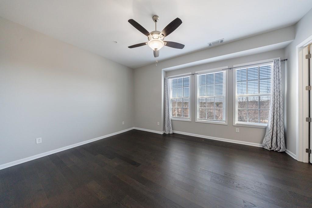 225 Britten Pass Alpharetta, GA 30009 - Photo 22 of 38 an empty room with wooden floor and ceiling fan