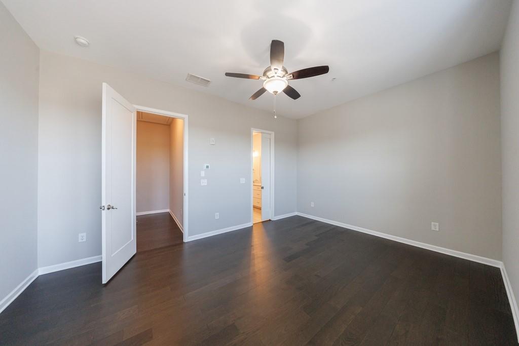 225 Britten Pass Alpharetta, GA 30009 - Photo 24 of 38 an empty room with wooden floor fan and windows
