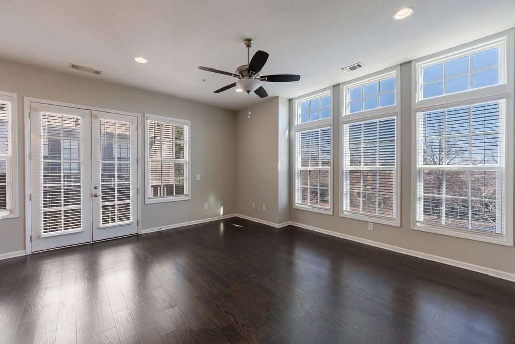 225 Britten Pass Alpharetta, GA 30009 - Photo 6 of 38 a view of an empty room with wooden floor and a window
