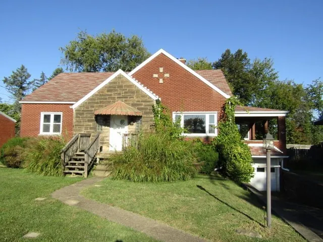 a front view of house with yard and green space