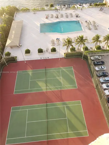 a room with pool table and chairs