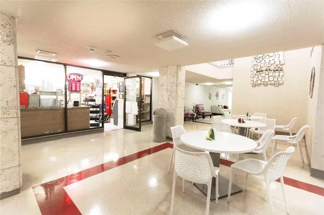 a dining room with furniture and a large window
