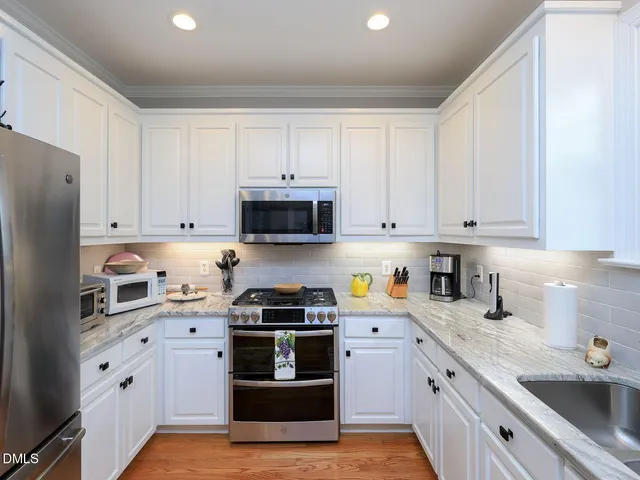 a bedroom with a bed window and dresser