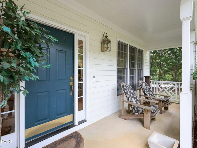 a view of balcony with couch and chairs