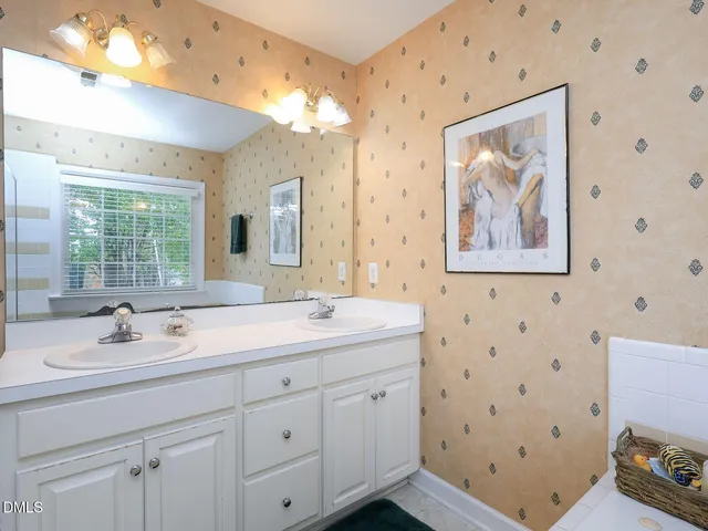 a bedroom with two beds and a chandelier