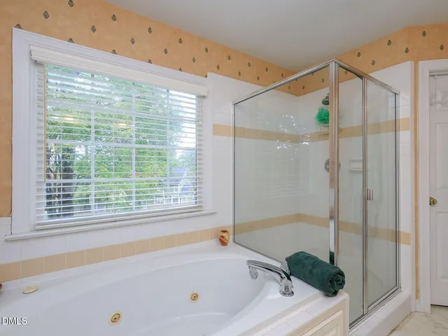 a bathroom with a sink vanity granite shower and a mirror