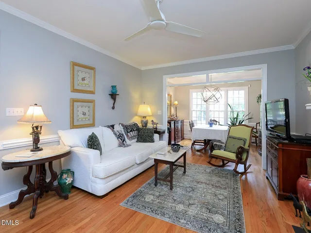 a living room with furniture fireplace and a window
