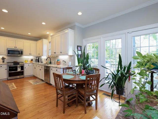 a kitchen with a table and chairs in it