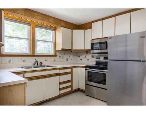 75 Hilldale Road Ashland, MA 01721 - Photo 16 of 37 a kitchen with stainless steel appliances granite countertop a sink a stove a refrigerator with grey cabinets