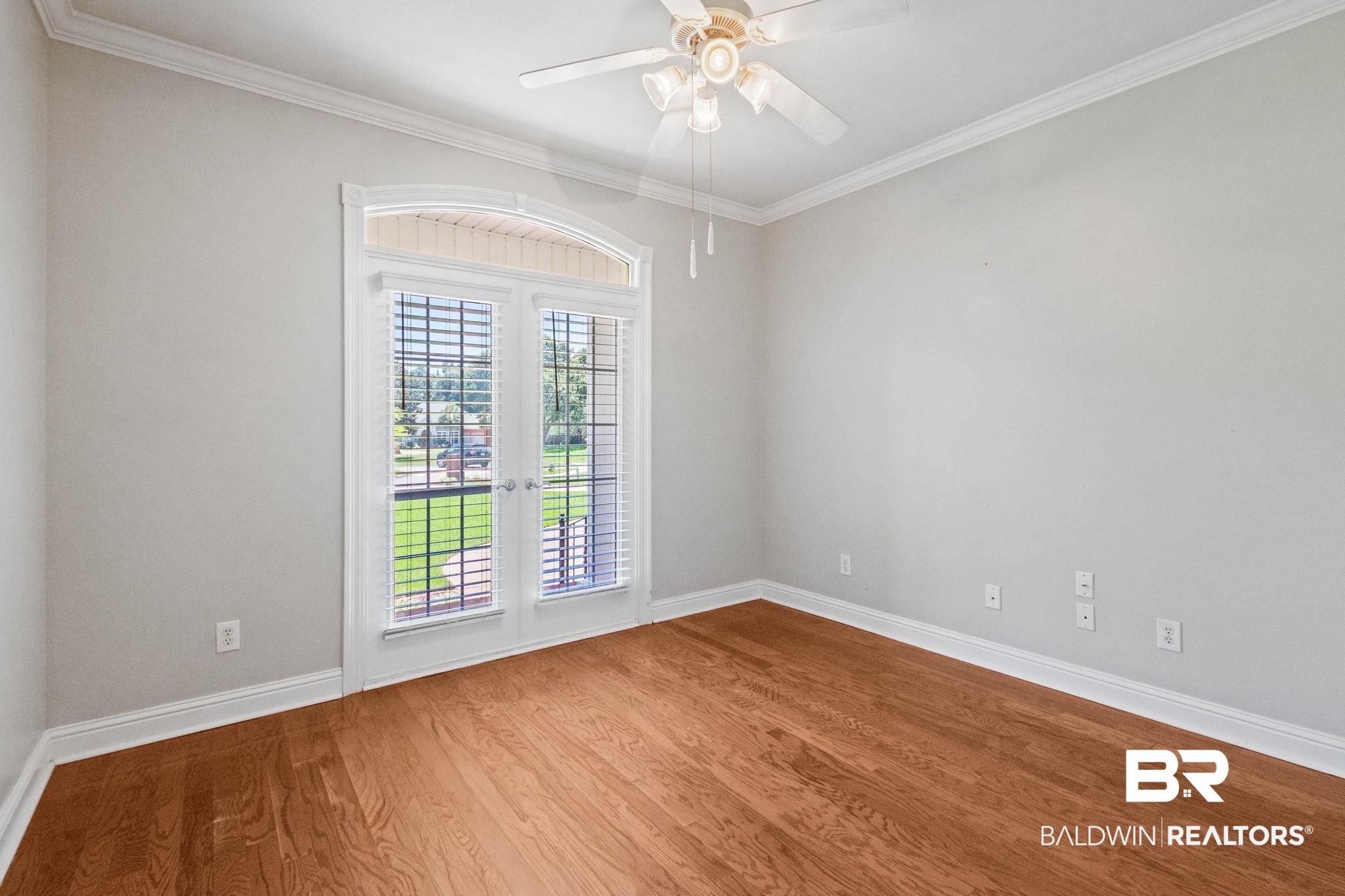 3176 Cedar Court Mobile, AL 36619 - Photo 19 of 33 Room featuring wood-finish flooring, light neutral wall paint, and white crown molding