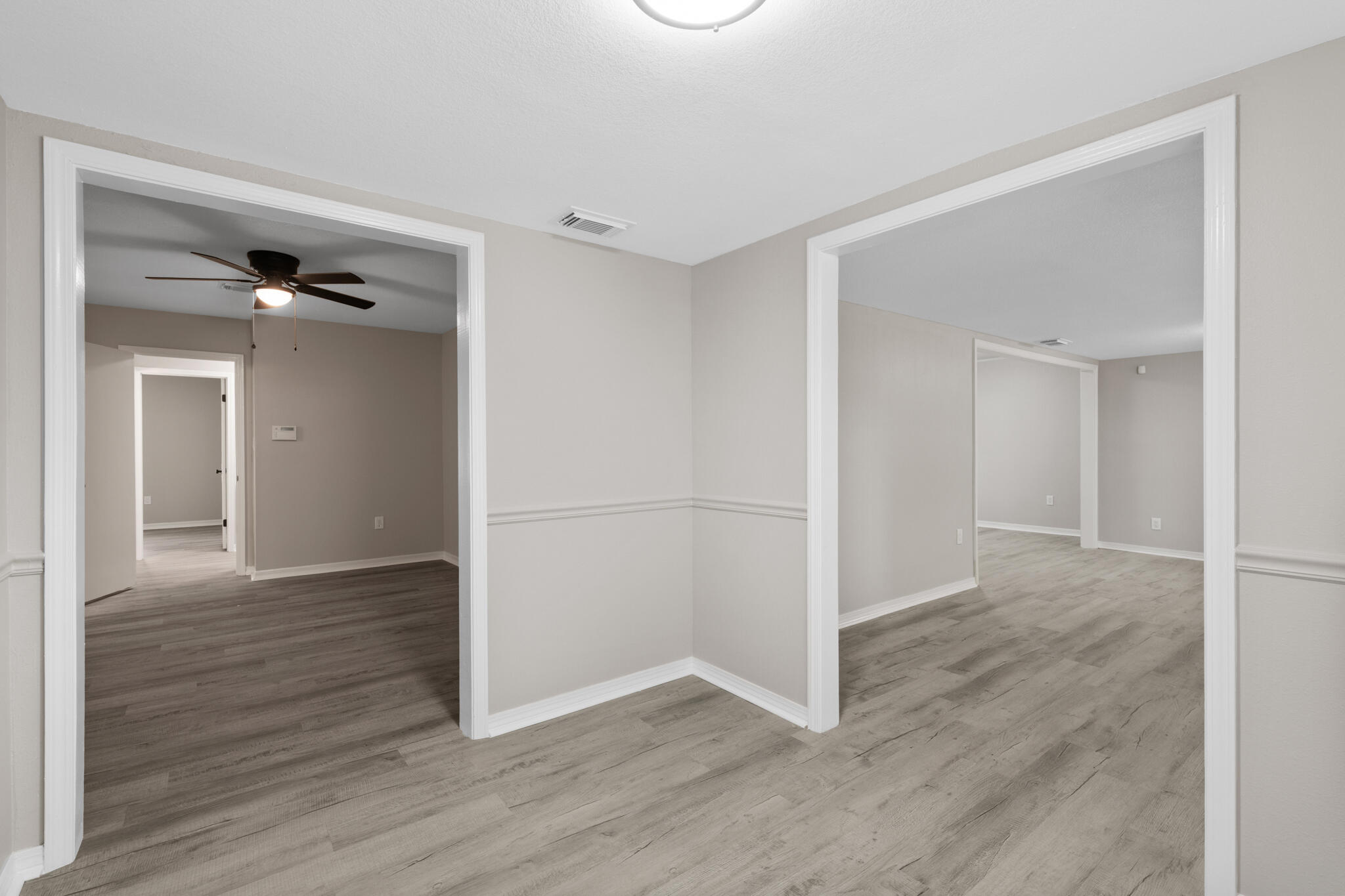 3437 Auburn Road Crestview, FL 32539 - Photo 11 of 26 a view of an empty room with wooden floor