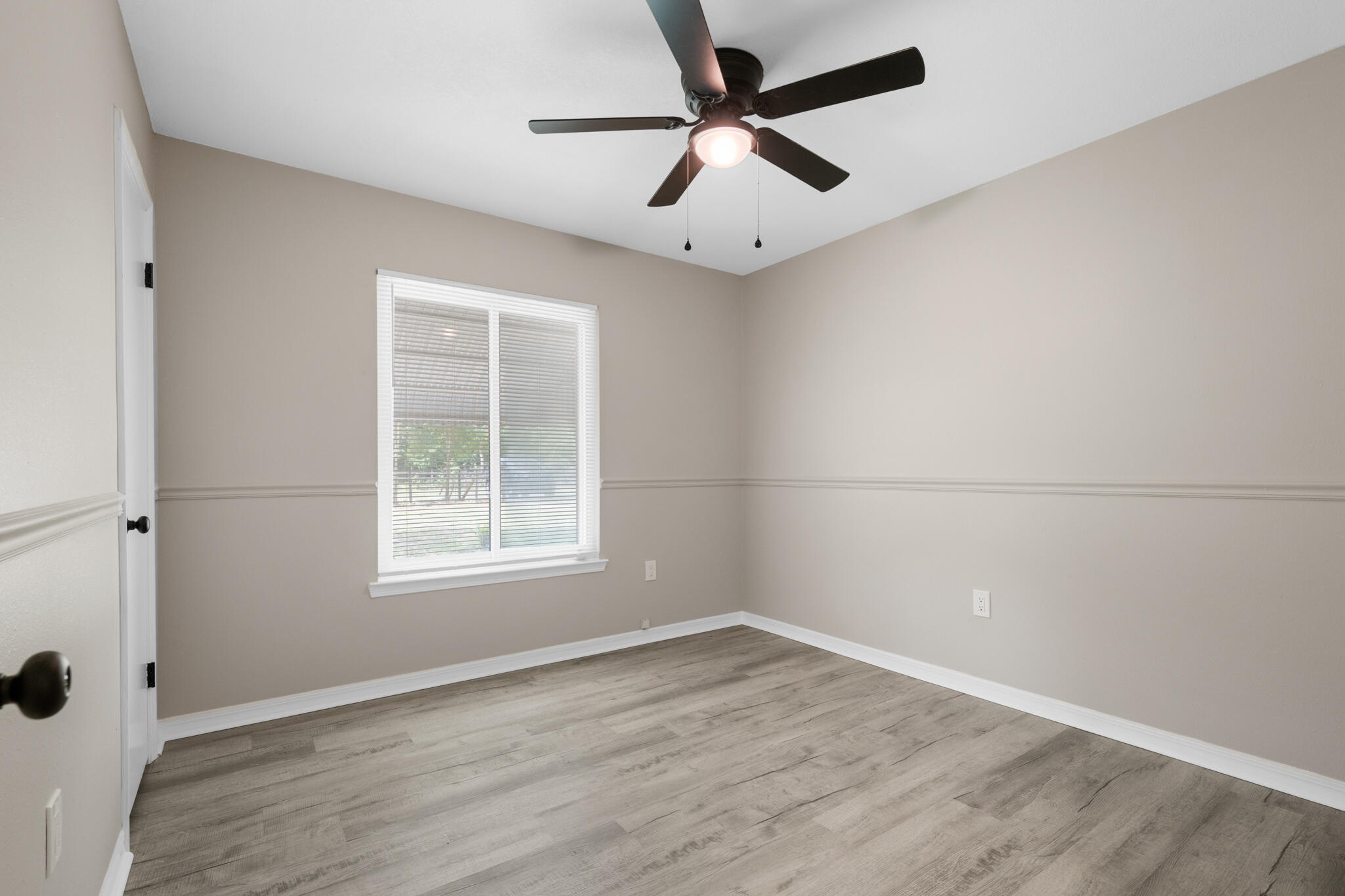 3437 Auburn Road Crestview, FL 32539 - Photo 13 of 26 an empty room with a window and a fan