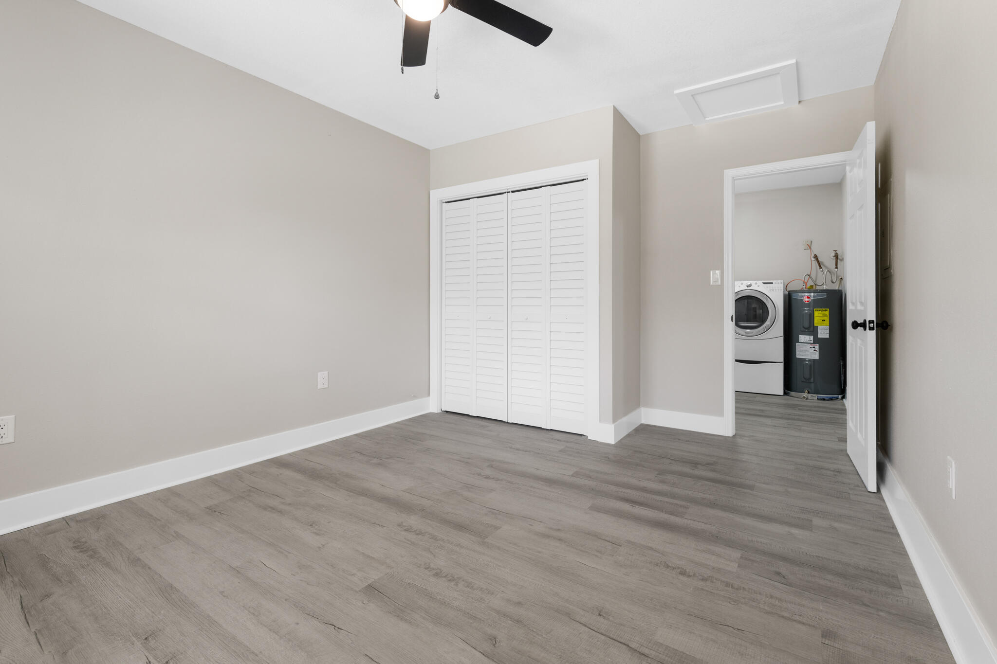3437 Auburn Road Crestview, FL 32539 - Photo 16 of 26 wooden floor in an empty room with a window