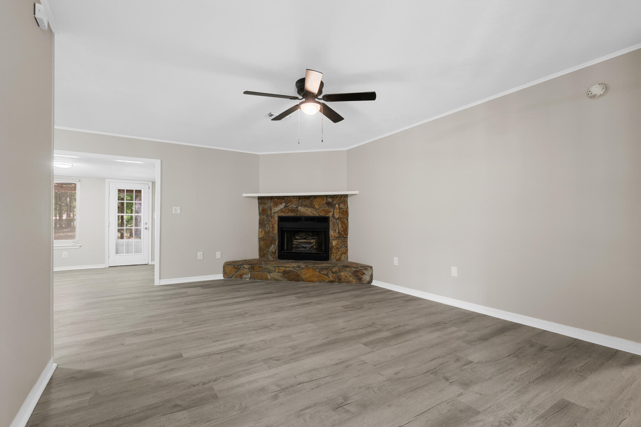 3437 Auburn Road Crestview, FL 32539 - Photo 17 of 26 an empty room with windows and fireplace