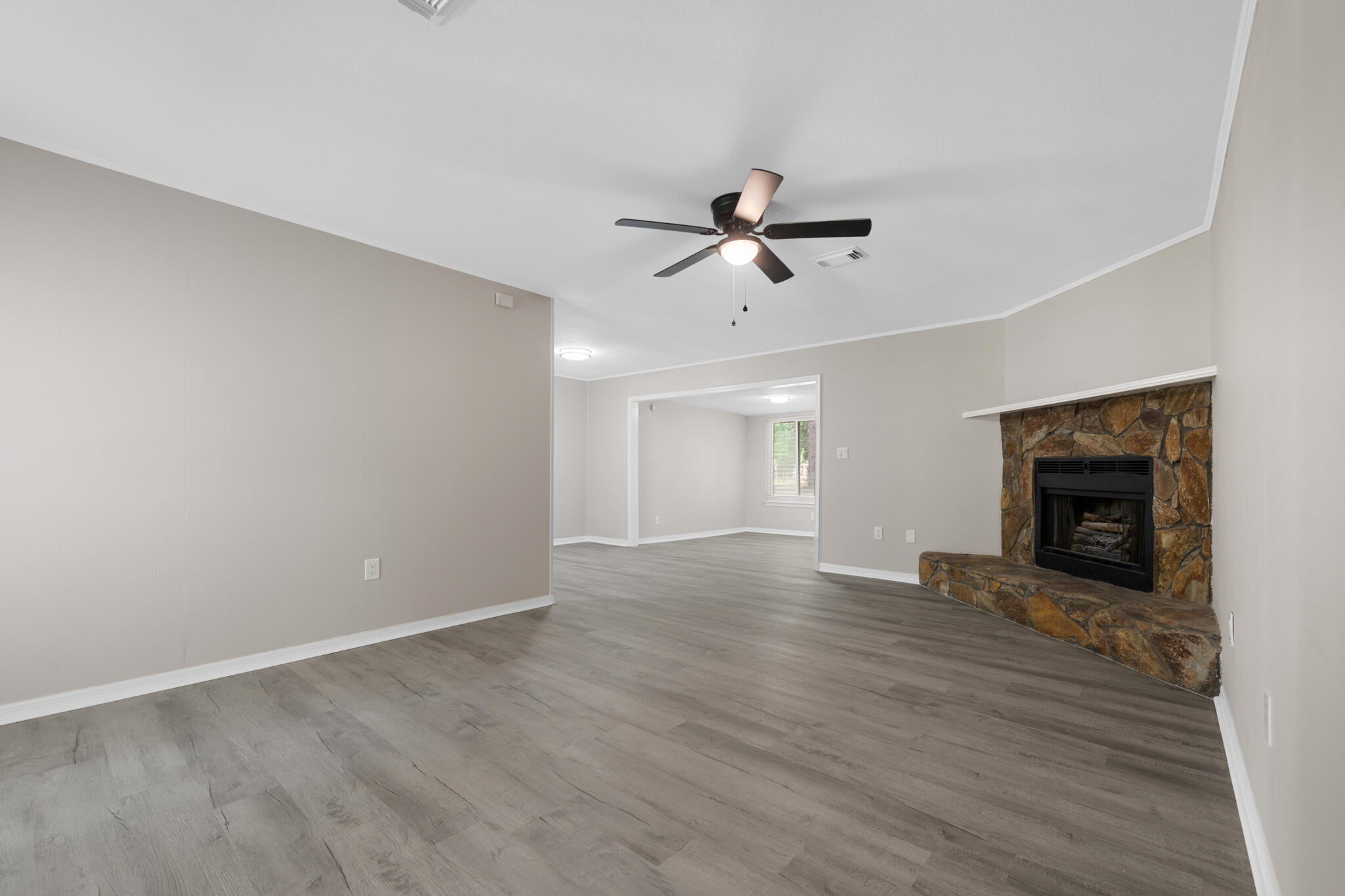 3437 Auburn Road Crestview, FL 32539 - Photo 22 of 26 a view of an empty room with a fireplace and a window