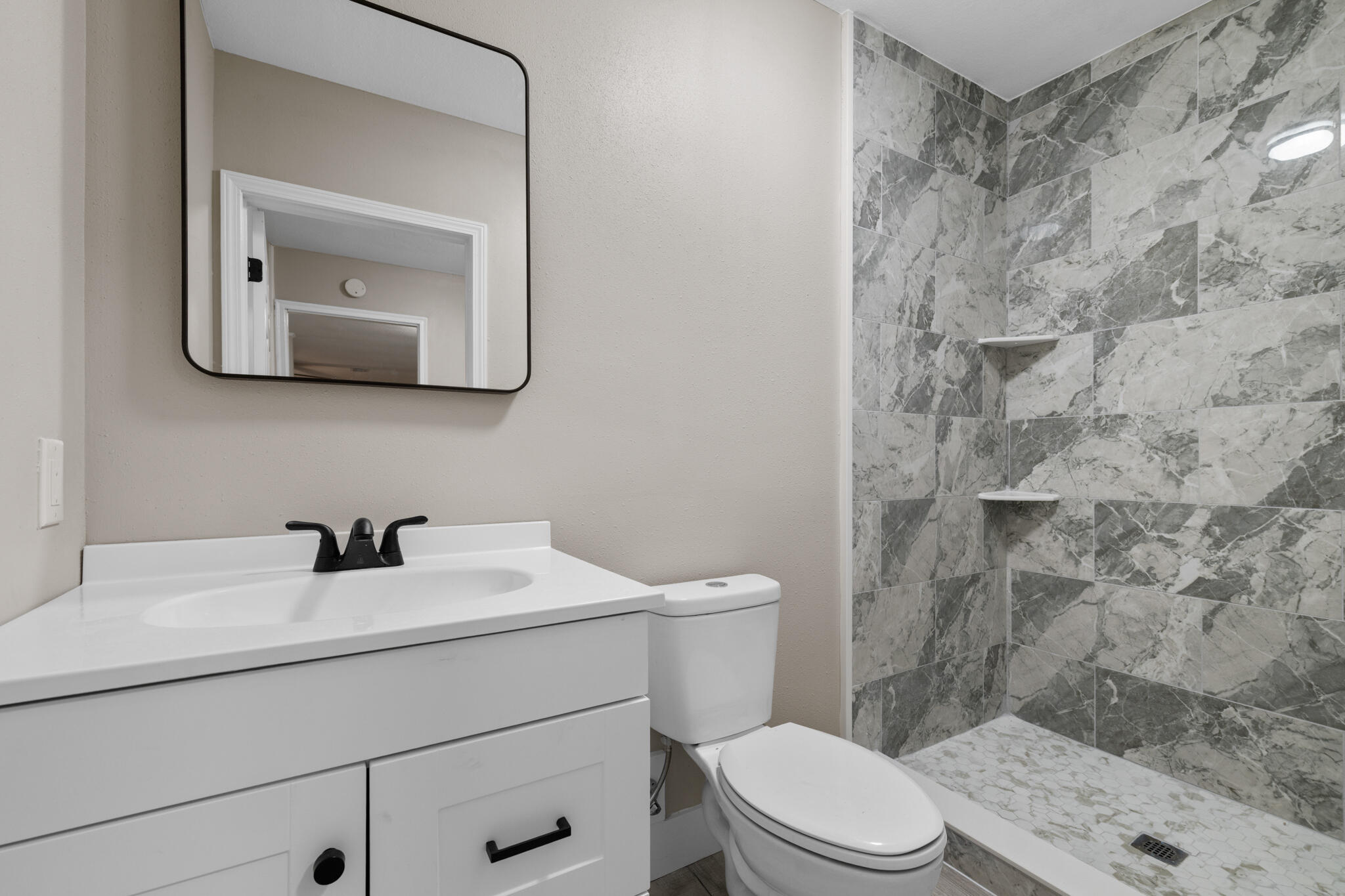 3437 Auburn Road Crestview, FL 32539 - Photo 3 of 26 a bathroom with a sink a toilet and mirror